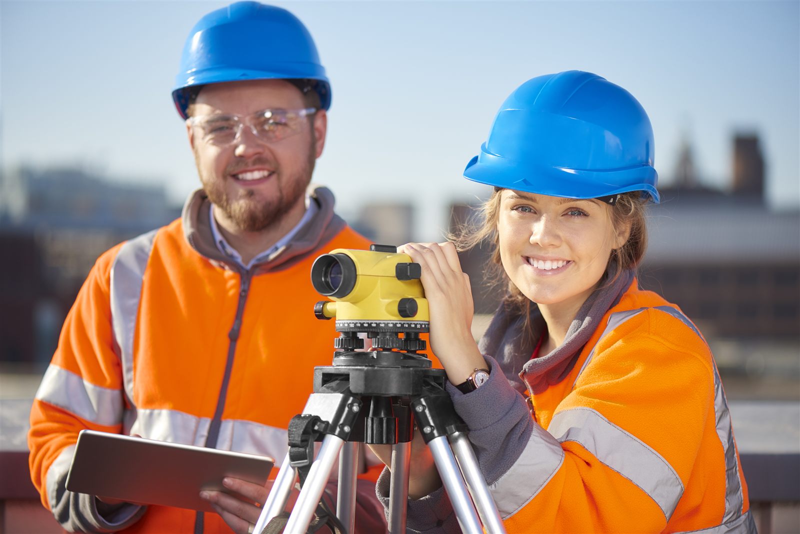 Two construction workers in hi-vis and hard hats on site in Sydney